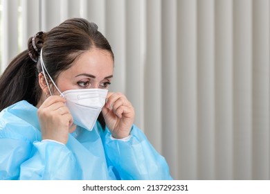 Doctor Adjusting Covid-19 N95 Mask In Admissions Office Before Patient Visits