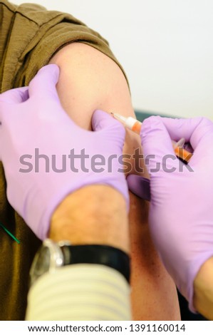 Doctor administers a vaccine to a female patient
