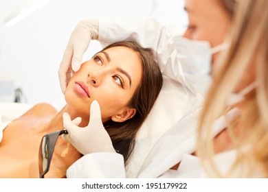 Doctor advising patient about a facelift in the beauty clinic - Shutterstock ID 1951179922