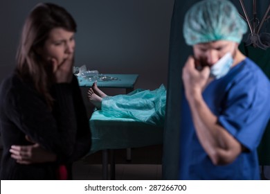 Doctor After Unsuccessful Surgery Talking With Patient's Family Member