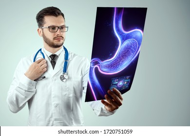 Doctor Against The Background Of A Hologram Of The Stomach, Endoscopy Procedure. Digestive Tract And Stomach Disease Concept. Mixed Medium, Copy Space