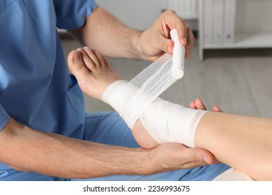 Doctor applying bandage onto patient's foot in hospital, closeup - Powered by Shutterstock