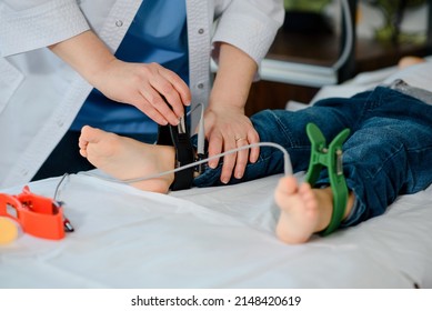 Doctor Applying ECG Electrodes On Child Seats For Pediatric Electrocardiogram To Diagnose Kids Cardiovascular Diseases. 
