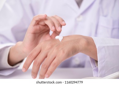 Doctor Applying Hand Cream