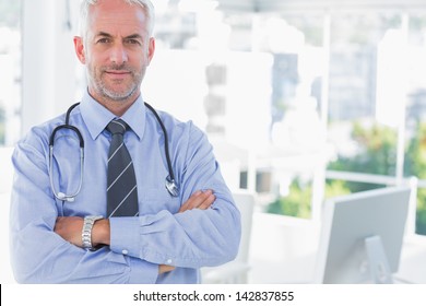 Doctor with arms crossed standing in front of the camera - Shutterstock ID 142837855