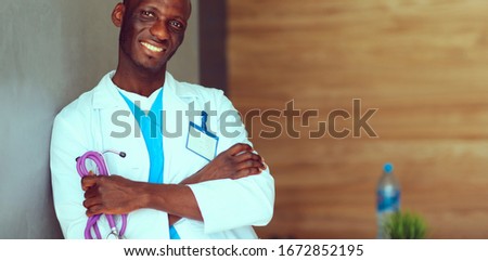 Doctor with arms folded in modern office. Doctor Stock photo © 