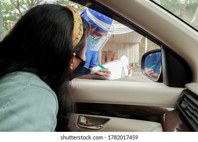 Doctor Ask Screening Questions Before Taking Drive Thru Rapid Blood Test For Covid-19