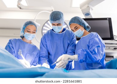 Doctor and assistant nurse operating for help patient from dangerous emergency case .Surgical instruments on the sterile table in the emergency operation room in the hospital.Health care and Medical - Powered by Shutterstock