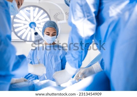 Doctor and assistant nurse operating for help patient from dangerous emergency case .Surgical instruments on the sterile table in the emergency operation room in the hospital.Health care and Medical