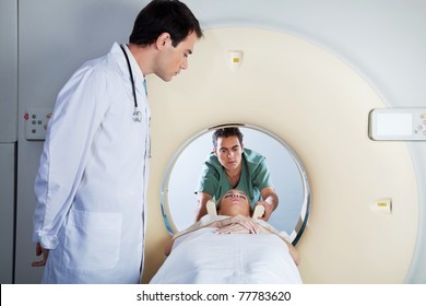 Doctor Assisting The MRI Scan With The Technician In The Laboratory