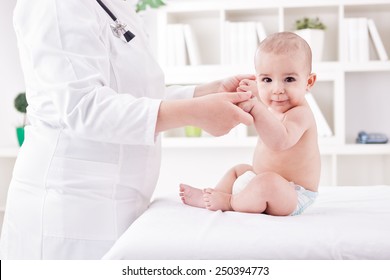 Doctor With Baby Doing Exercises
