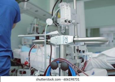 Doctor At The Bedside In Modern Hospital Room.