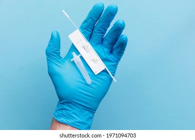 Doctor in blue gloves using a lateral flow covid-19 testing kit - Shutterstock ID 1971094703