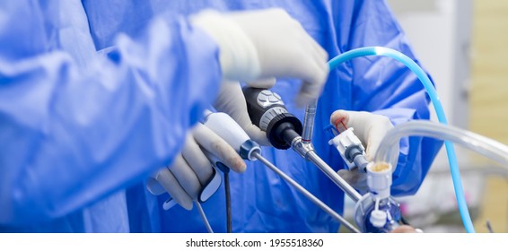 Doctor In Blue Sterile Surgical Gown Suite Doing Minimal Invasive Surgery With Camera And Instrument.Keyhold Surgery Was Perform In Modern Operating Room.Advanced Surgery.