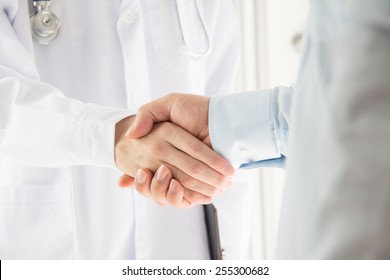 Doctor And Businessman Shaking Hands