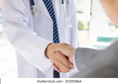 Doctor And Businessman Shaking Hands