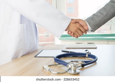 Doctor And Businessman Shaking Hands