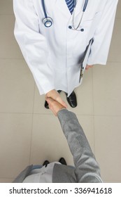 Doctor And Businessman Shaking Hands