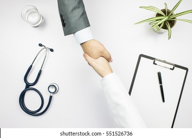 Doctor And Businessman Shaking Hands