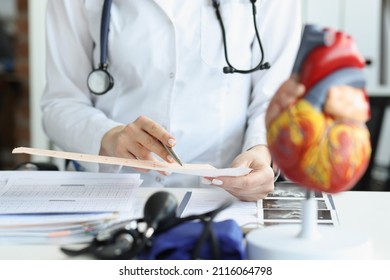 Doctor Cardiologist Examining Cardiogram Against Background Stock Photo ...