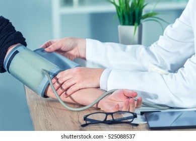 Doctor Cardiologist Measuring Blood Pressure Of Female Patient In Hospital Office, Health Care Control And Monitoring.