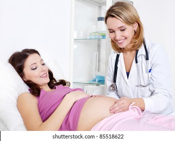 Doctor Care about young pregnant woman in hospital - indoors