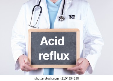 A Doctor With A Chalkboard Acid Reflux Written On It