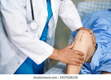 Doctor Check Asian Senior Or Elderly Old Lady Woman Patient Scars Surgical Total Knee Joint Replacement Suture Wound Surgery Arthroplasty At Nursing Hospital Ward : Healthy Strong Medical Concept.    