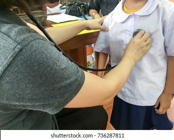 a doctor check up a girl body at school