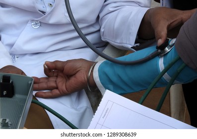  Doctor Check Or  Measure BP Or Blood Pressure  Level Of Man In A Medical Camp           