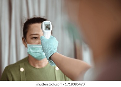 Doctor Check Patient Body Temperature Using Infrared Forehead Thermometer At Hospital For Corona Virus. Coronavirus, Covid-19, Work From Home, Social Distancing, Quarantine, Prevent Infection Concept.