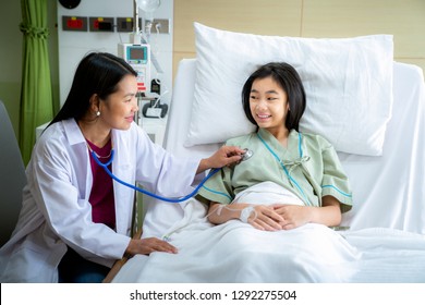 Doctor check pulse and check STETHOSCOPE on the bed in patient room in Hospital, this immage can use for insurance, doctor, hospital, occupation and healthcare concept,