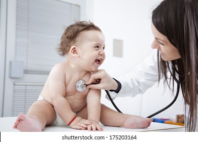 Doctor checking up baby with stethoscope. 