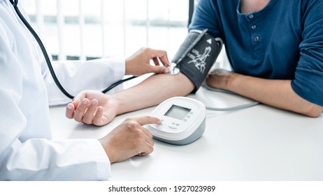 The Doctor Is Checking Blood Pressure And Is Also Using A Stethoscope, To Check For The Cause Of The Patient's Illness And To Advice Health Care At Hospital Office