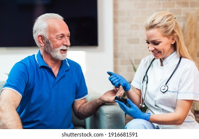 Doctor Checking Blood Sugar Level With Glucometer Of Senior Man. Diabetes Test. Healthcare Concept.