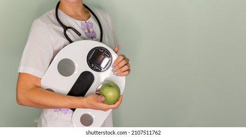 Doctor checking body with a professional scale. Health care, fitness and weight loss. Smart scales that makes bioelectric impedance analysis, BIA. Analysis of body composition measurement. - Powered by Shutterstock