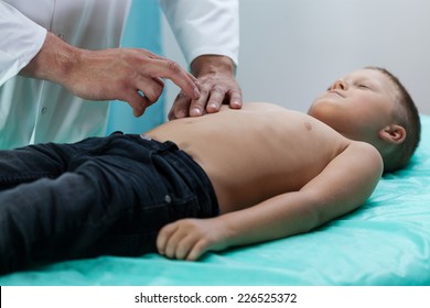 Doctor Checking Boy Belly Because Of Abdominal Pain