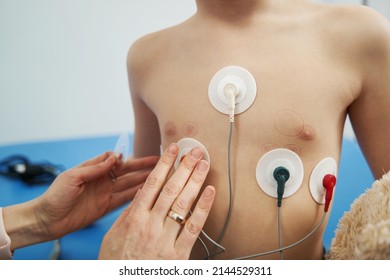 Doctor Checking Child Heart Rhythm With ECG Holter Monitor