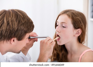 Doctor Checking Child Sore Throat