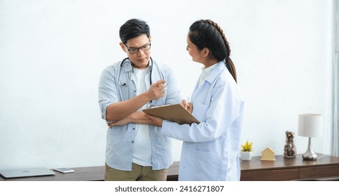 Doctor checking consultation with patient for checkup. work on healthcare paperwork and happiness of medical professional, checklist and report a results in hospital clinic, health insurance business - Powered by Shutterstock