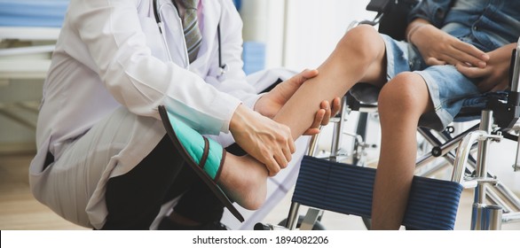 Doctor Checking Disabled Person Pateint Leg At Hospital, Muscle Weakness