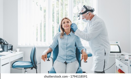 Doctor Checking Ear Of Middle Aged Woman Using Otoscope