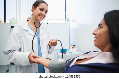 Doctor Checking Female Patients Blood Pressure In Hospital Room, Healthcare Workers In The Coronavirus Covid19 Pandemic