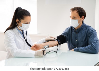 Doctor Checking High Blood Pressure In Face Mask