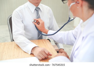 Doctor Checking Male Patient Heart Beat
