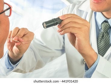 doctor checking mouth throat adult patient on modern hospital background
