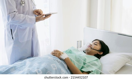 Doctor Is Checking The Patient Information During Covid 19 Outbreak, Quarantine Infected Patient Lying In Bed In Hospital , Coronavirus Covid-19concept