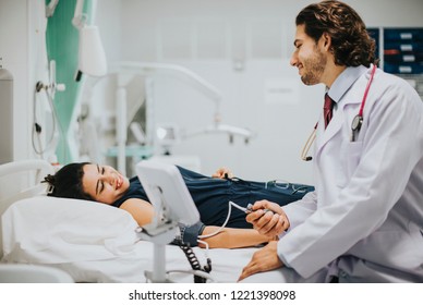 Doctor checking a patients blood pressure - Shutterstock ID 1221398098