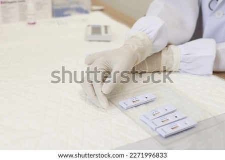 Doctor checking Sample test for HIV and Syphilis, Rapid test for HIV and syphilis, STD Testing specialist in clinic.