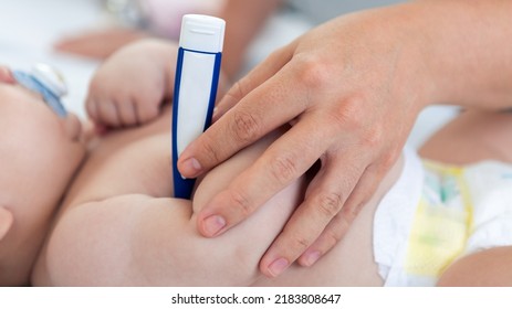 Doctor Checking The Temperature Fever To Small Newborn With Thermometer. Cute Boy And Chubby Hands Of A Child. A Newborn Age Of 3 Months. Pediatrician's Appointment, Maternity Concept